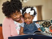 Mother reads with daughter